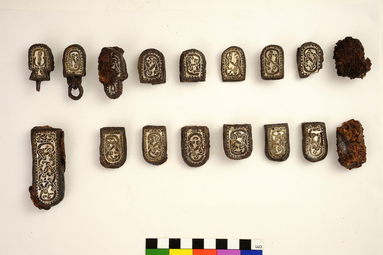 Burial items from Tomb 143 at Collegno: iron 'multiple' belt elements with silver and brass inlay